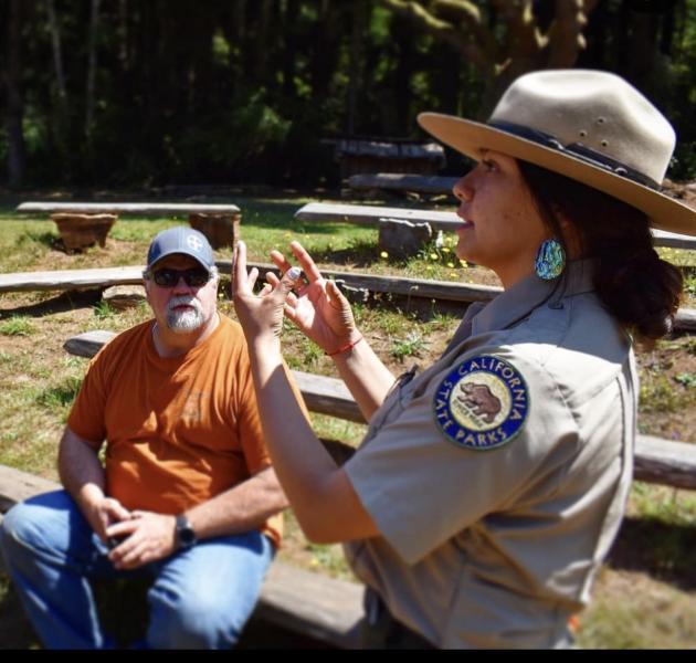 Talking about the Yurok culture to a park visitor in the Sumeg Village.