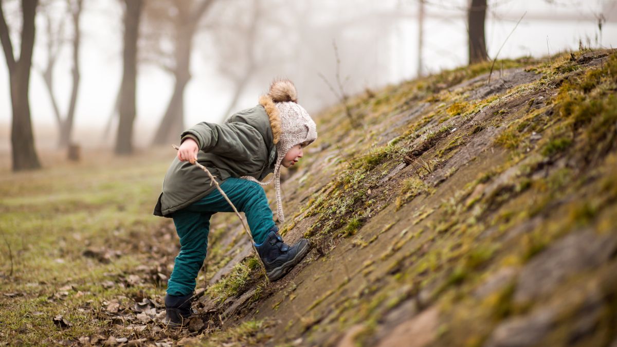 toddler playing outside in cool weather