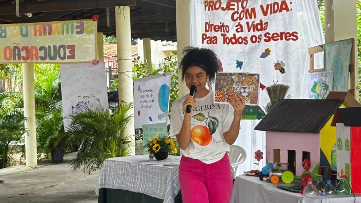 A young woman speaking in front of a group of students