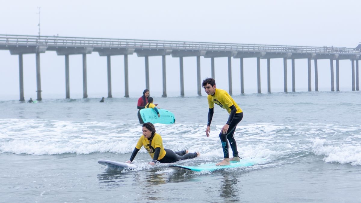 2 youth on surfboards