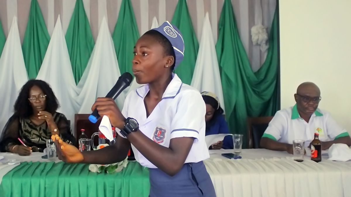Young woman speaking into a microphone