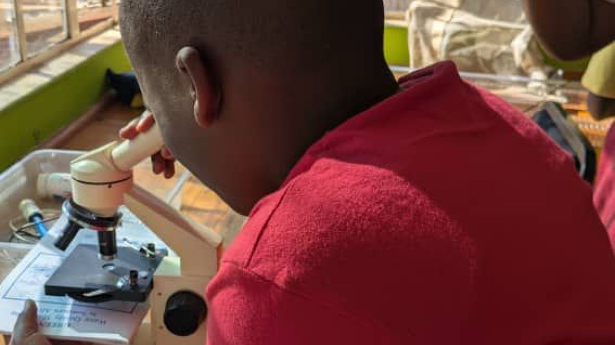 boy looking through microscope
