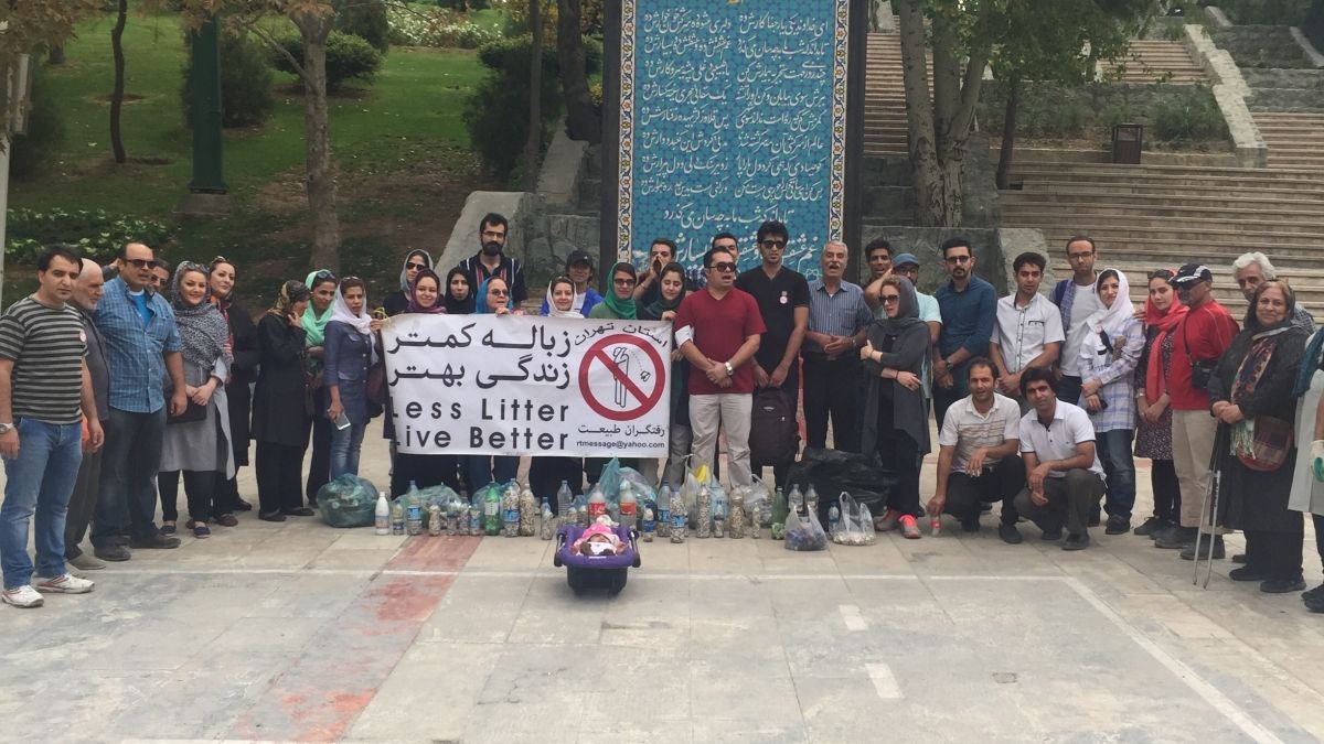 Students posing outside with a banner