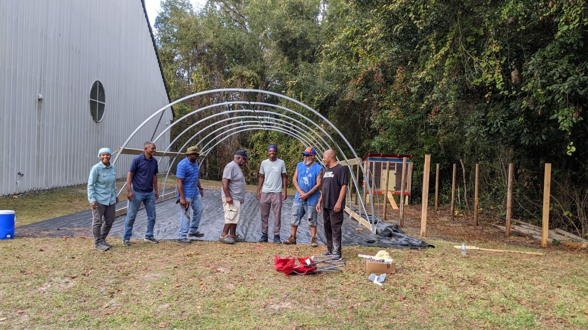 Group in front of a greenhouse