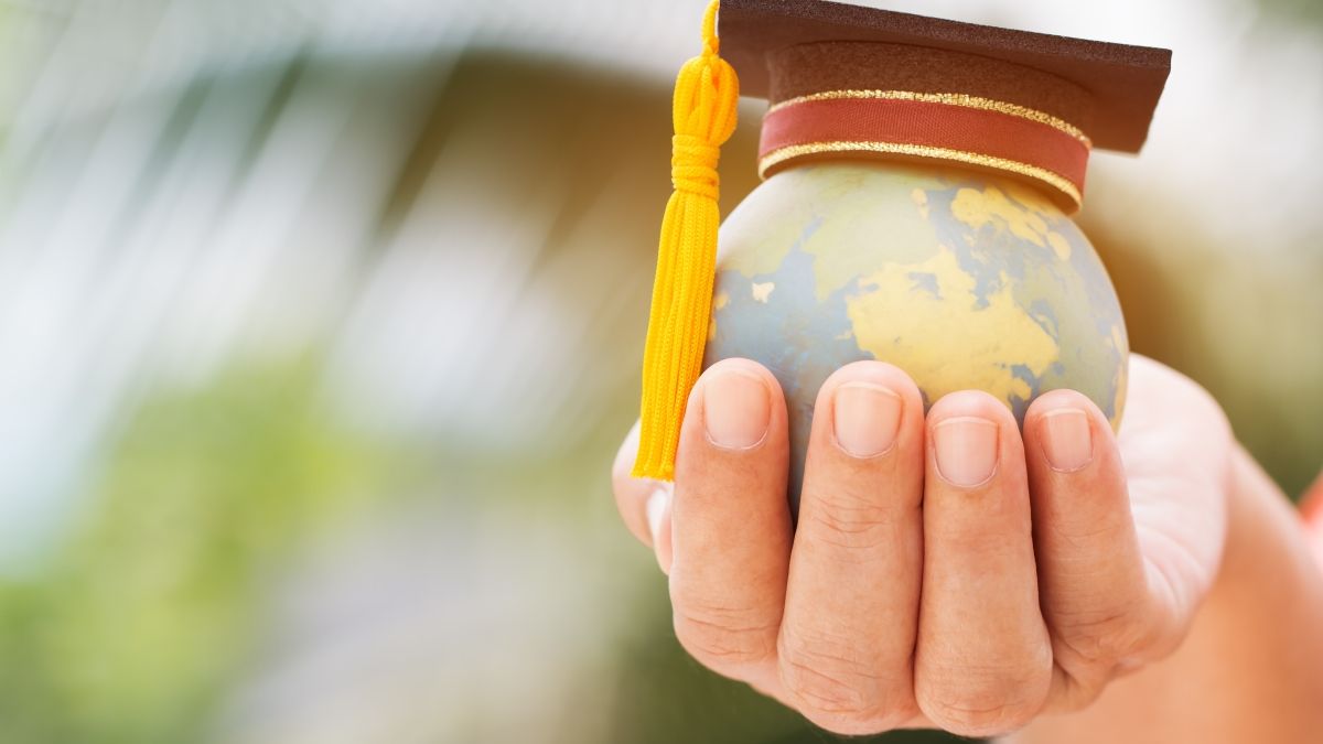 Hand holds a small model globe