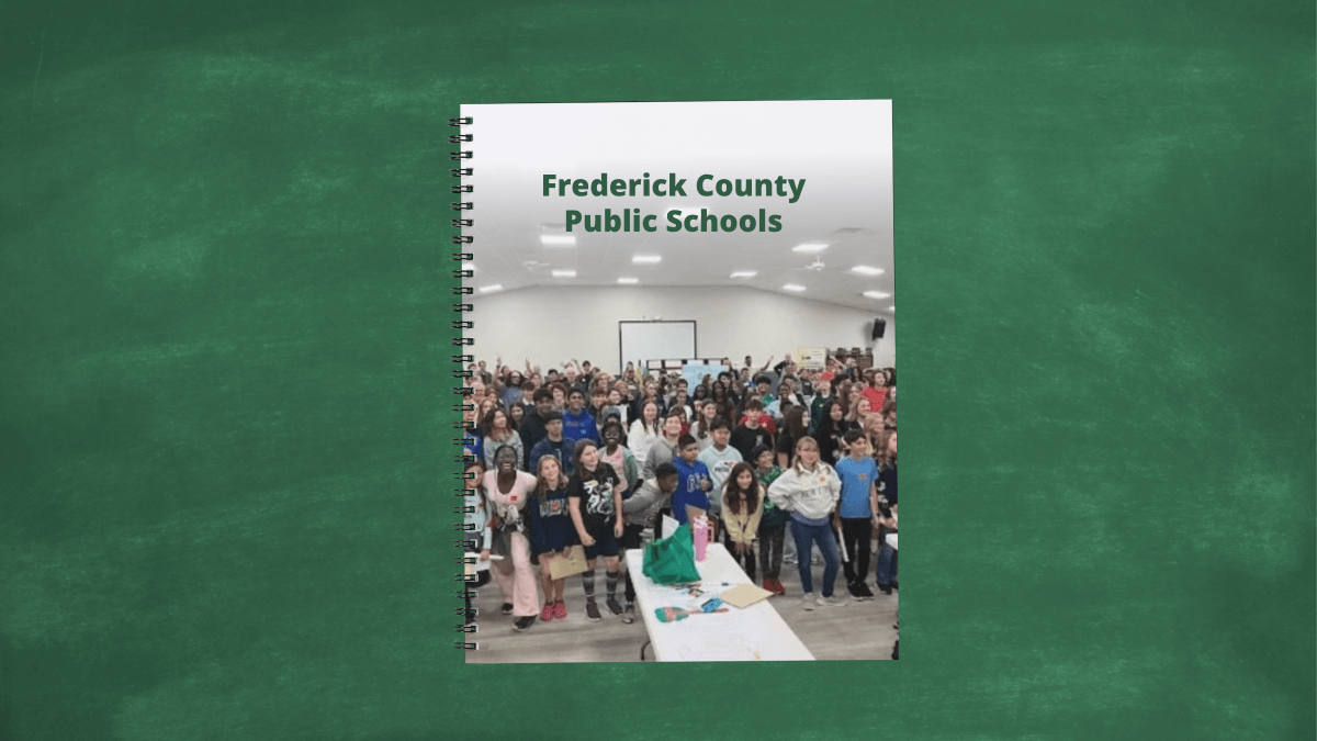 Notebook mock up with cover showing a group of students in an assembly room