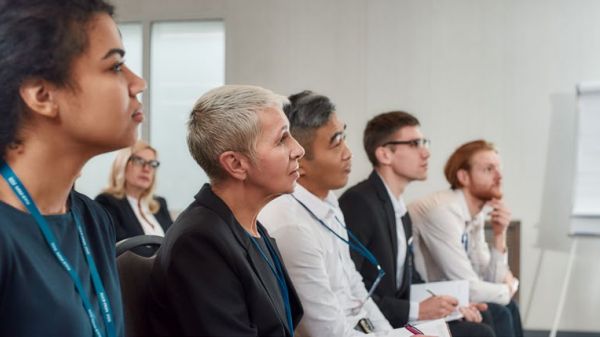 Adults sitting in a row and paying attention