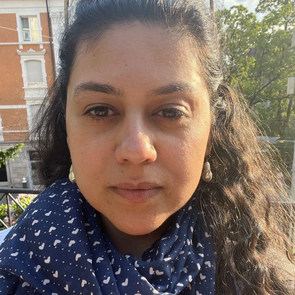 A person with a blue and white scarf wrapped around their neck