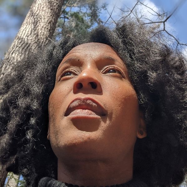 Woman's head shot in front of a tree