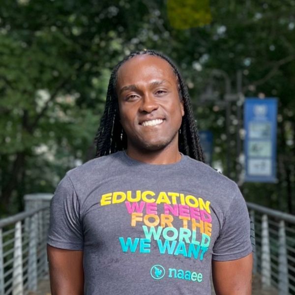 Shaul outside wearing an NAAEE T-shirt