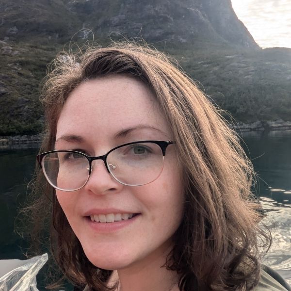 Tiffany outside with mountains and water in the background