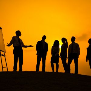 group of people against orange background attending presentation