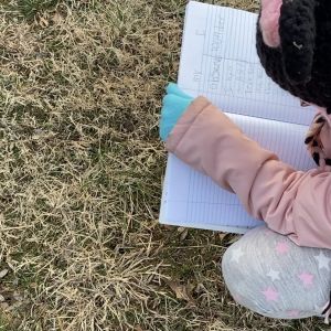 Student outside with a notebook