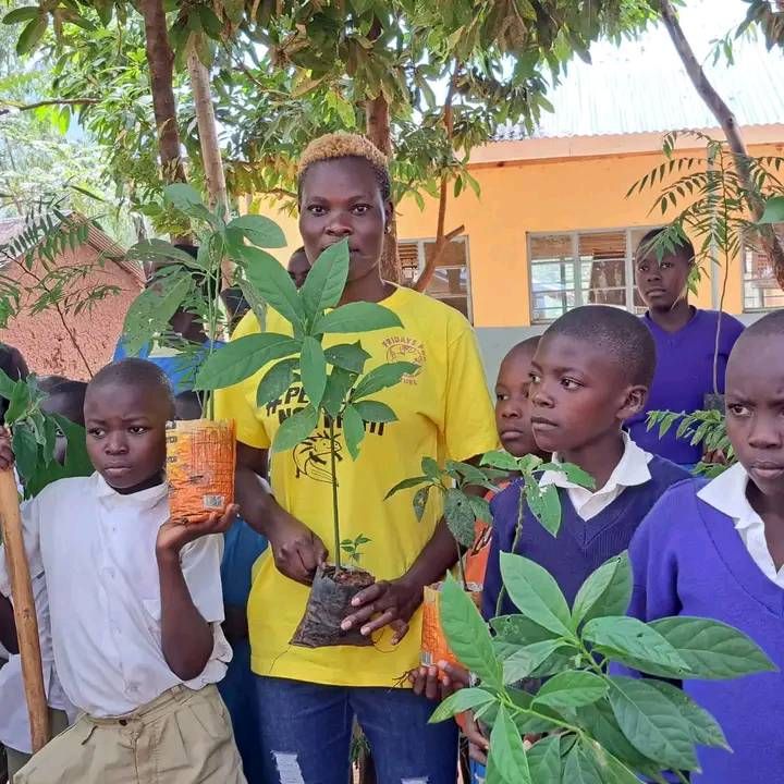 Pauline Owiti with kids tree planting
