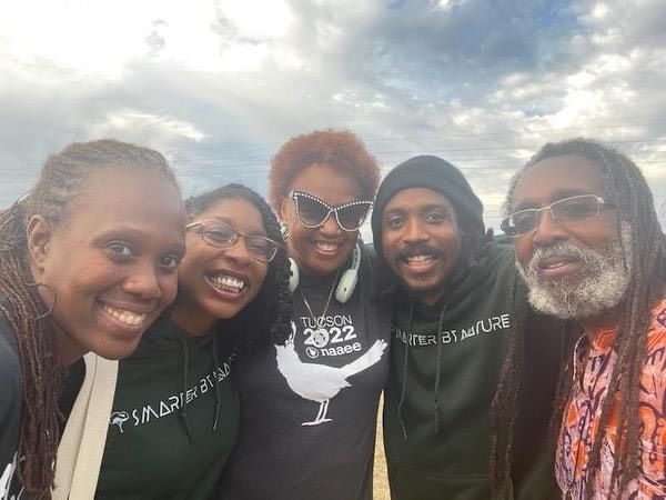 A group photo of five people outside