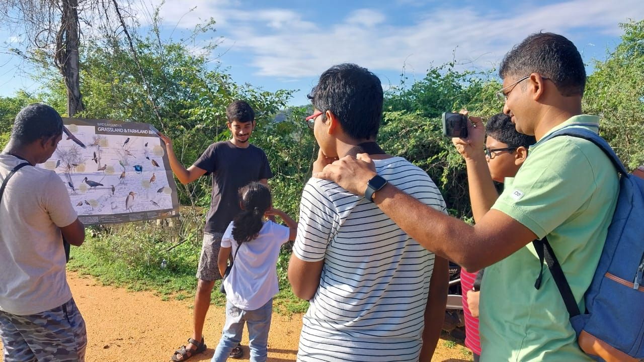 Sharan uses EarlyBird's Birds Around Us - grassland and farmlands poster during a bird walk