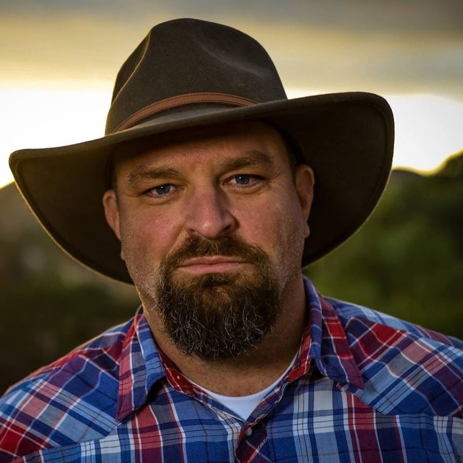Griff Griffith in a hat and plaid button up