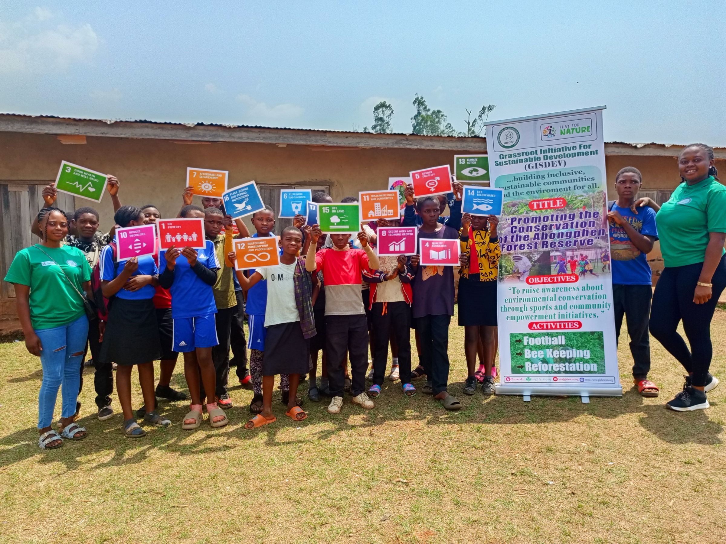 A group of students holding up SDG signs.