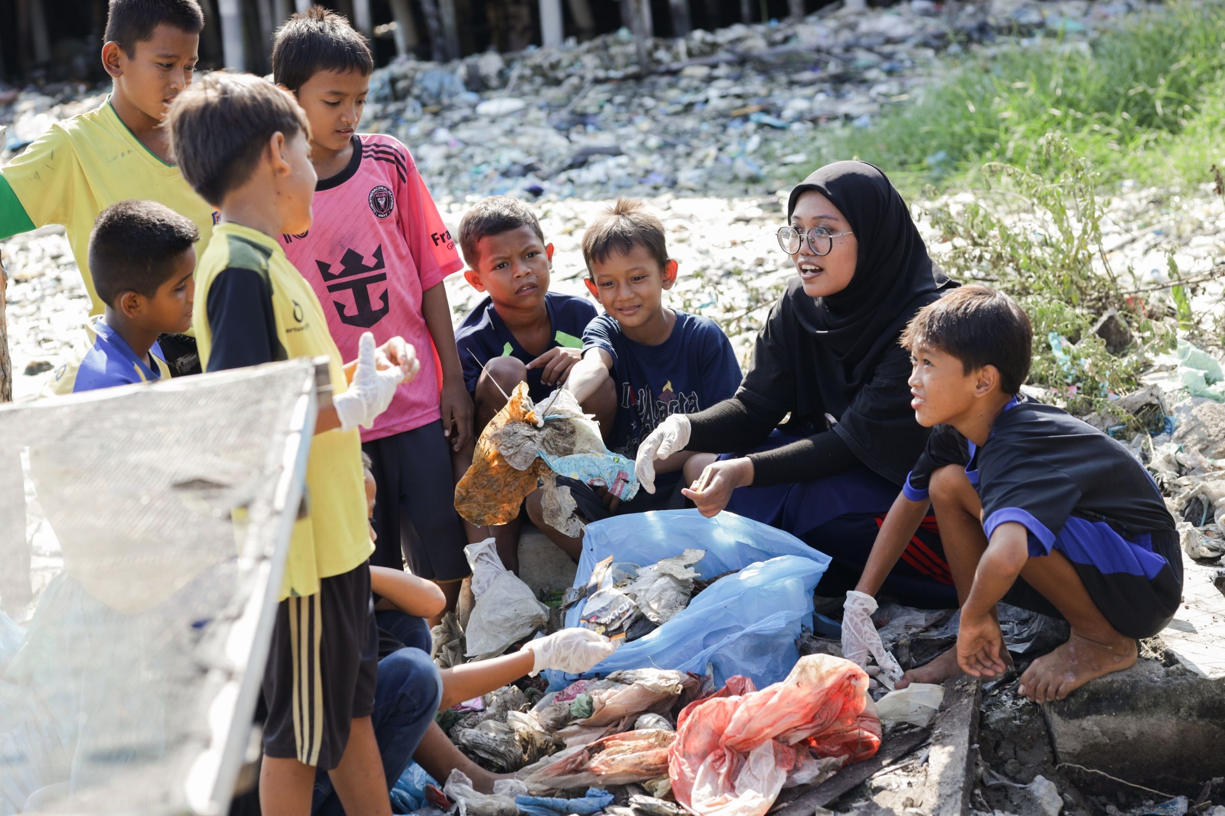 A teacher with students outside.