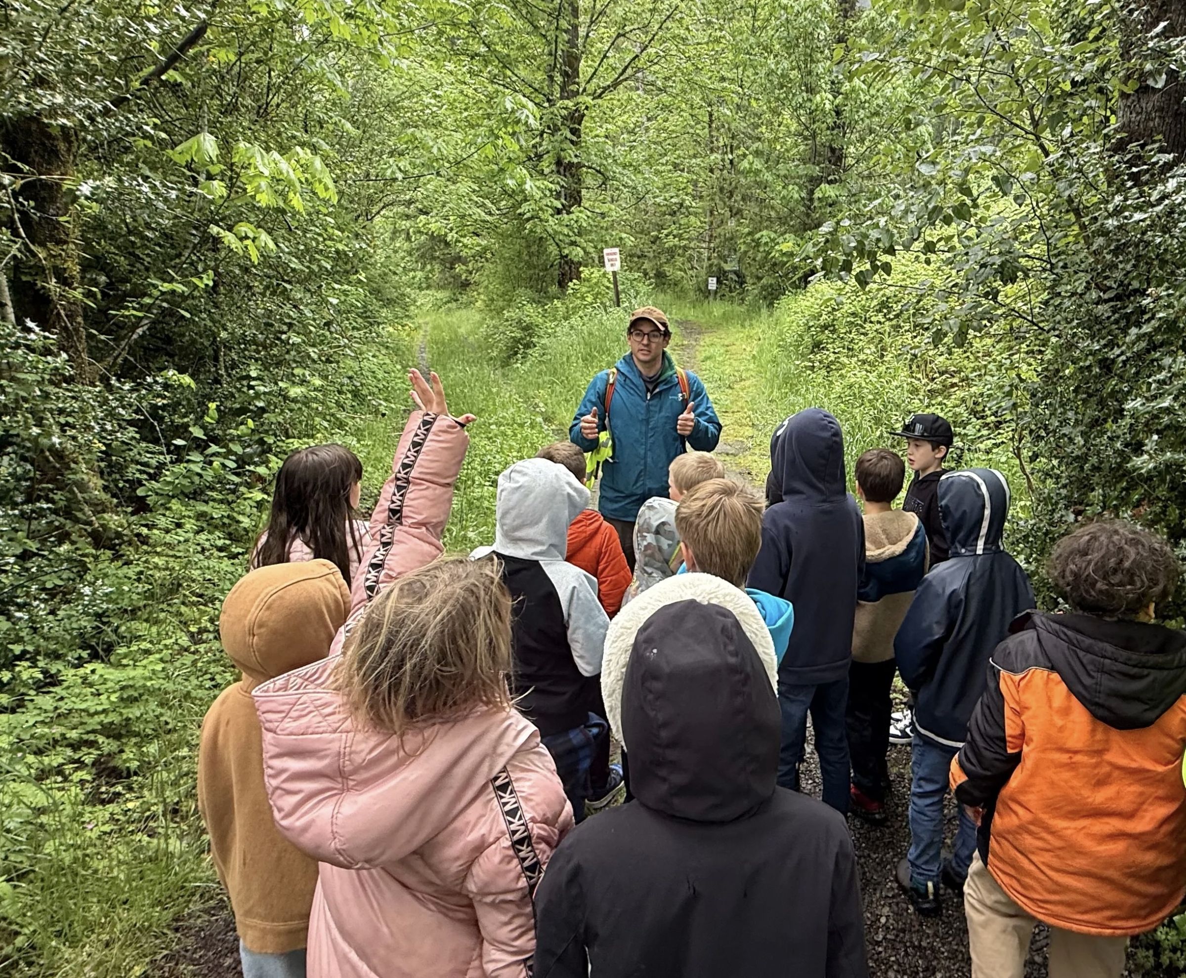 Adam leading a group of people outside