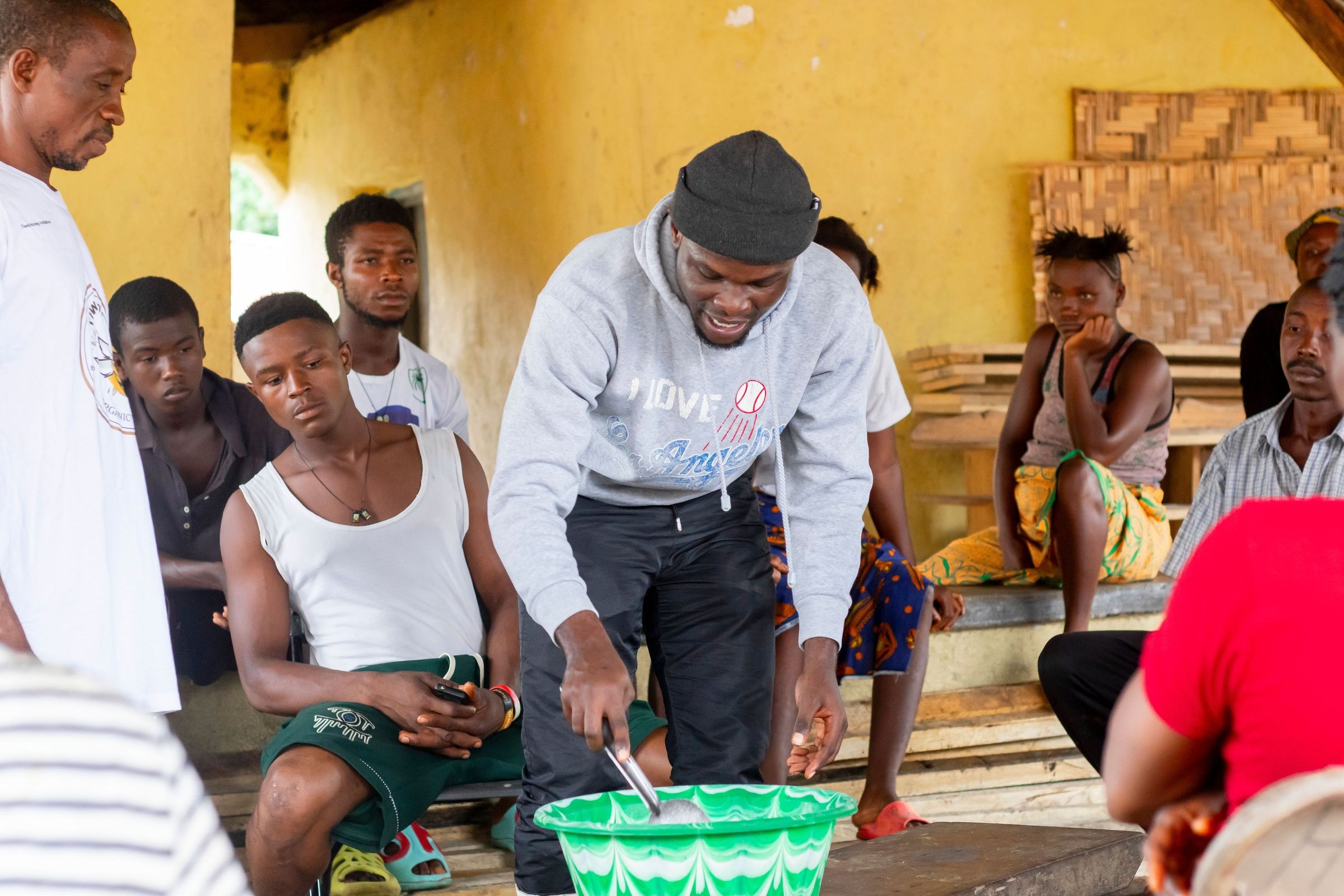 A man working on beekeeping with a group of community members.
