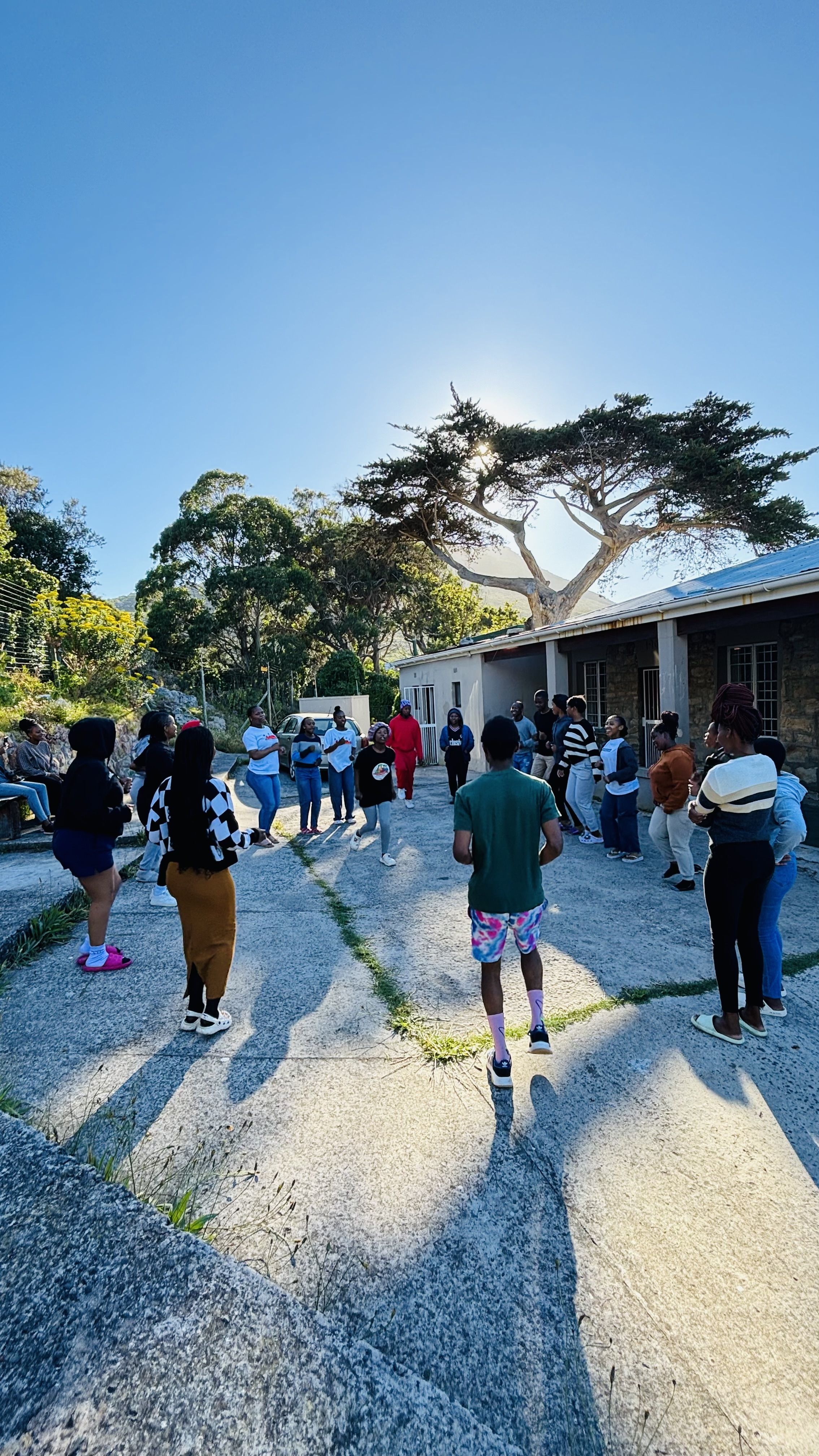 A group of students in a circle outside.