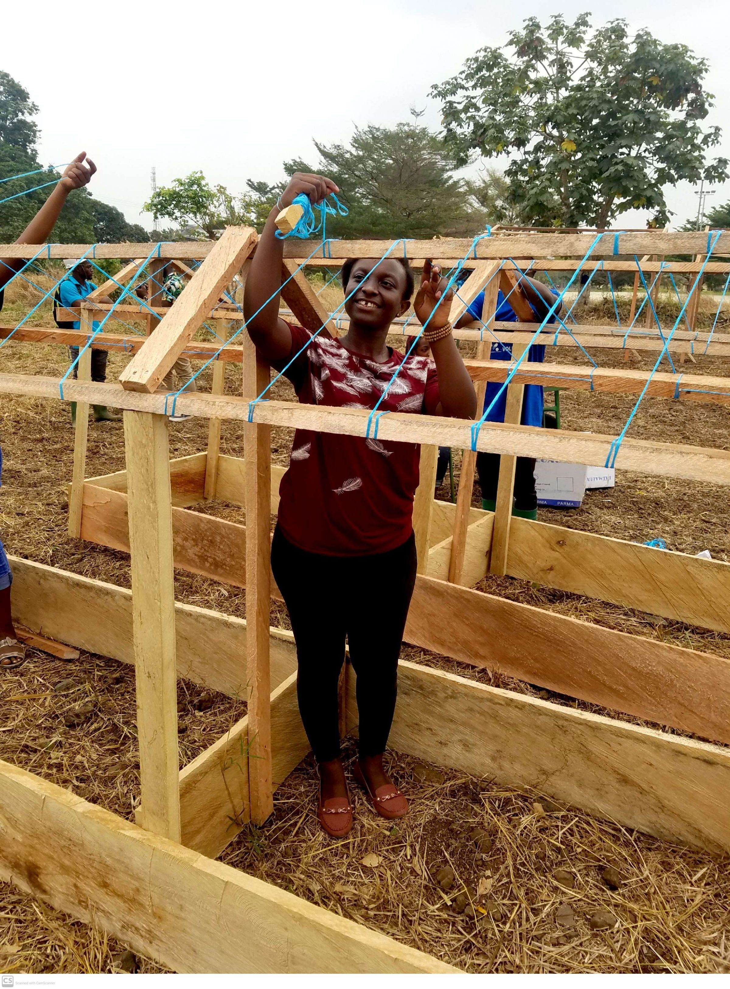 EE 30 Under 30 Awardee Nora shows Participants of the PVCA Phase II project how to build green houses for Plantain propagation using local materials. 