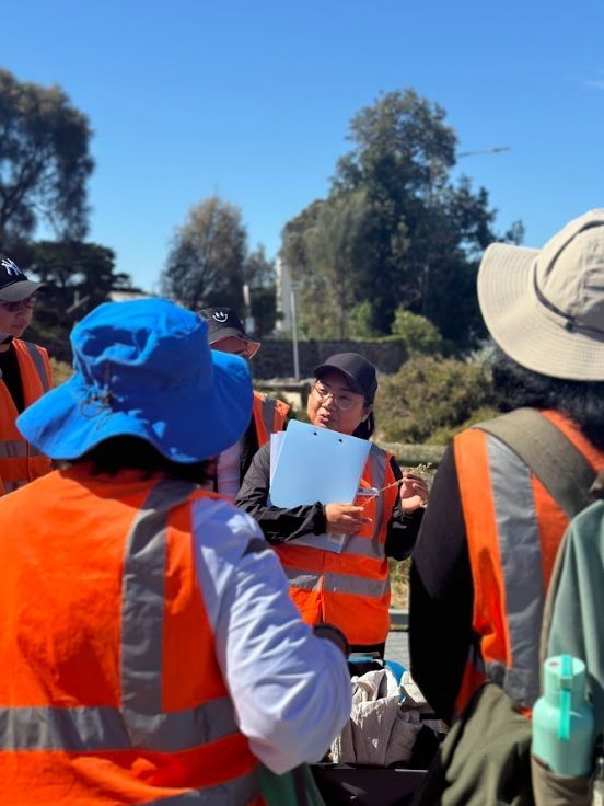 A group of people in high-visibility vests outdoors.