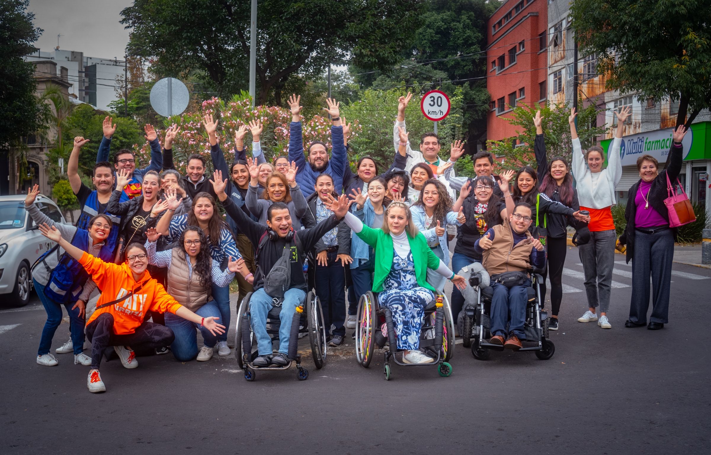 A group of people posing on a crosswalk.