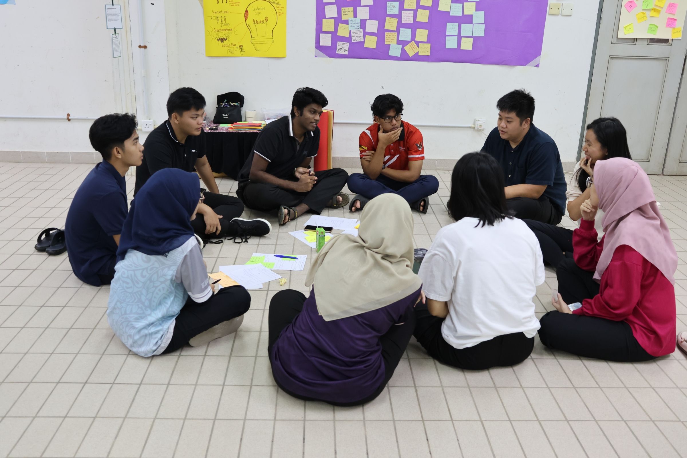 A group of young people sitting in a circle.