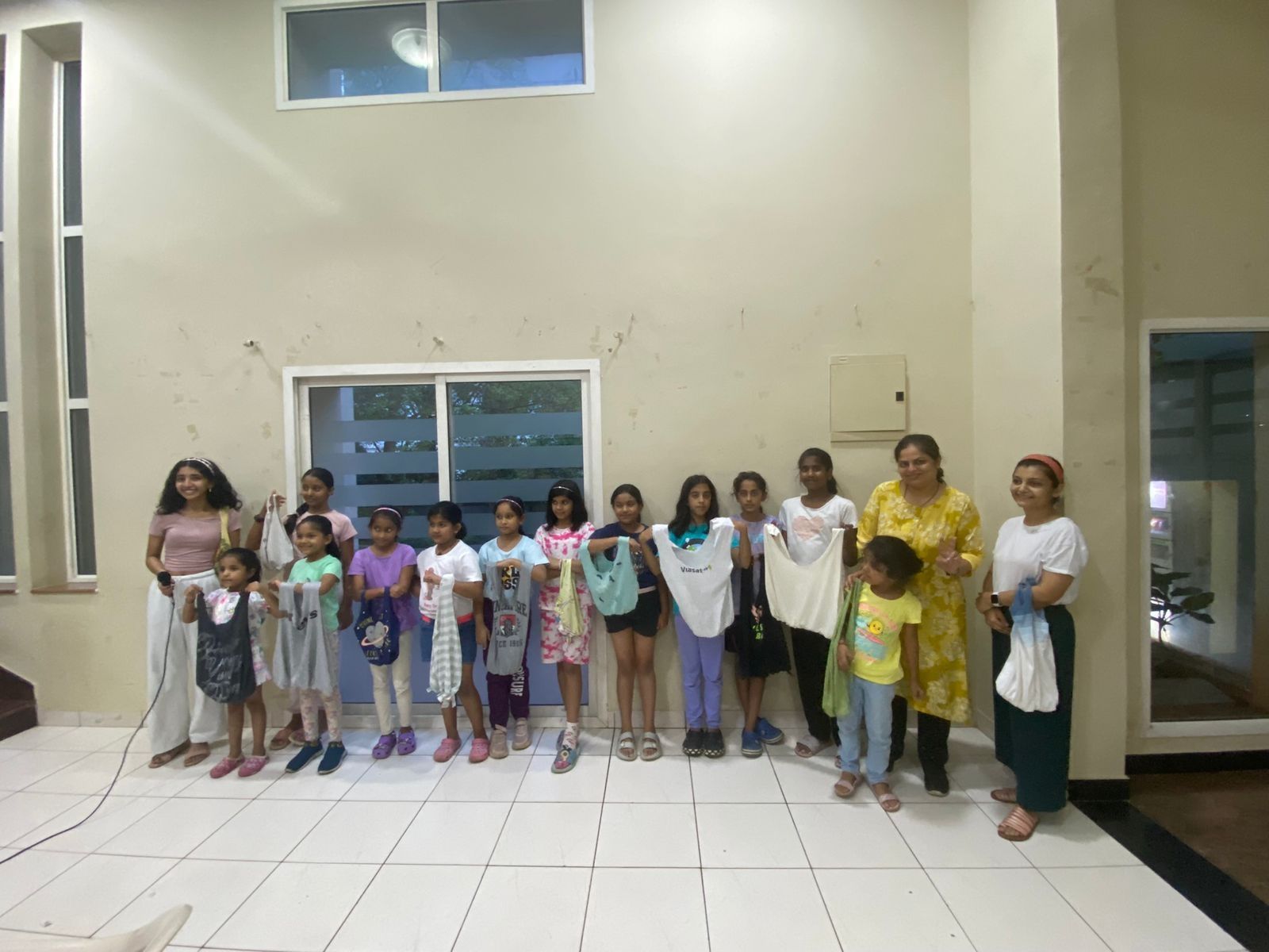 A group of children holding up bags they made.
