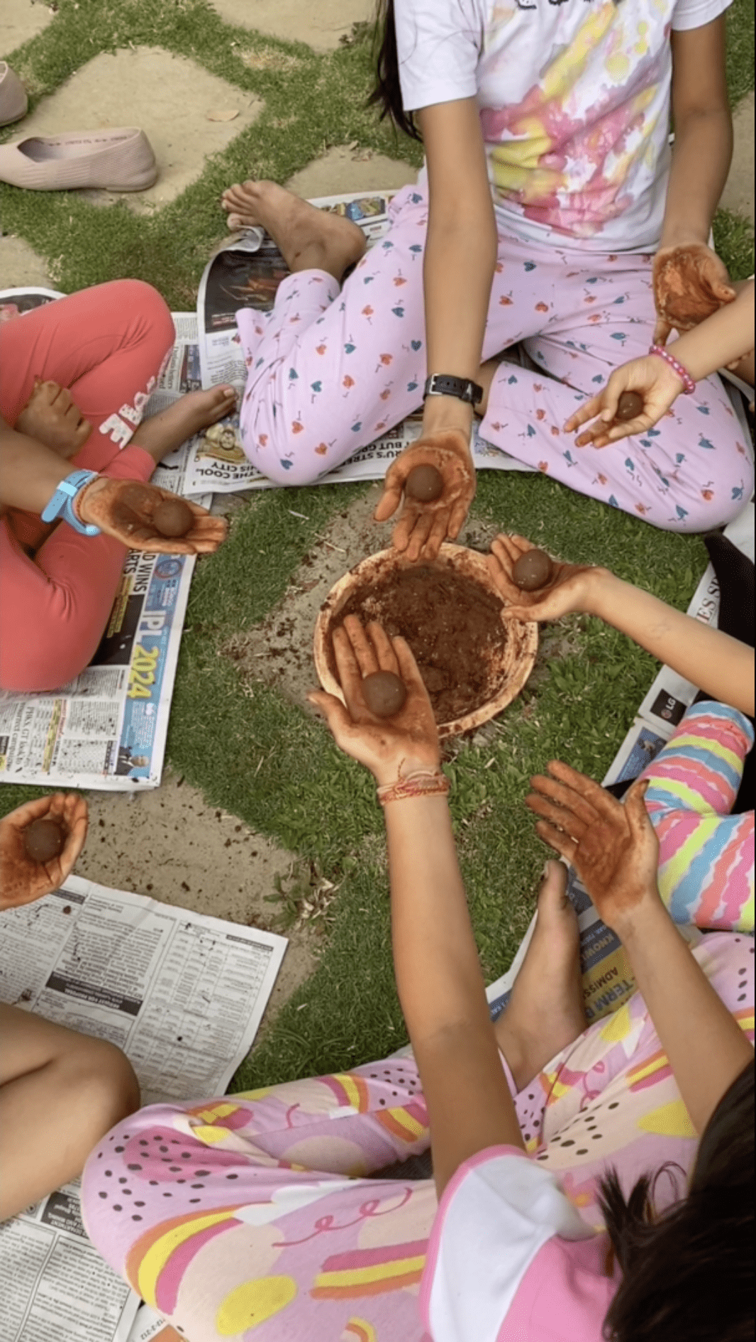 Young children holding their seedballs.