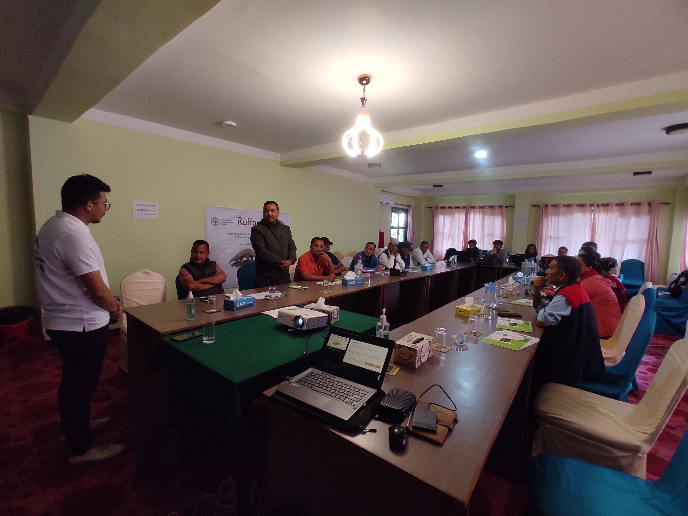 A man presenting to a group of people in a conference room.