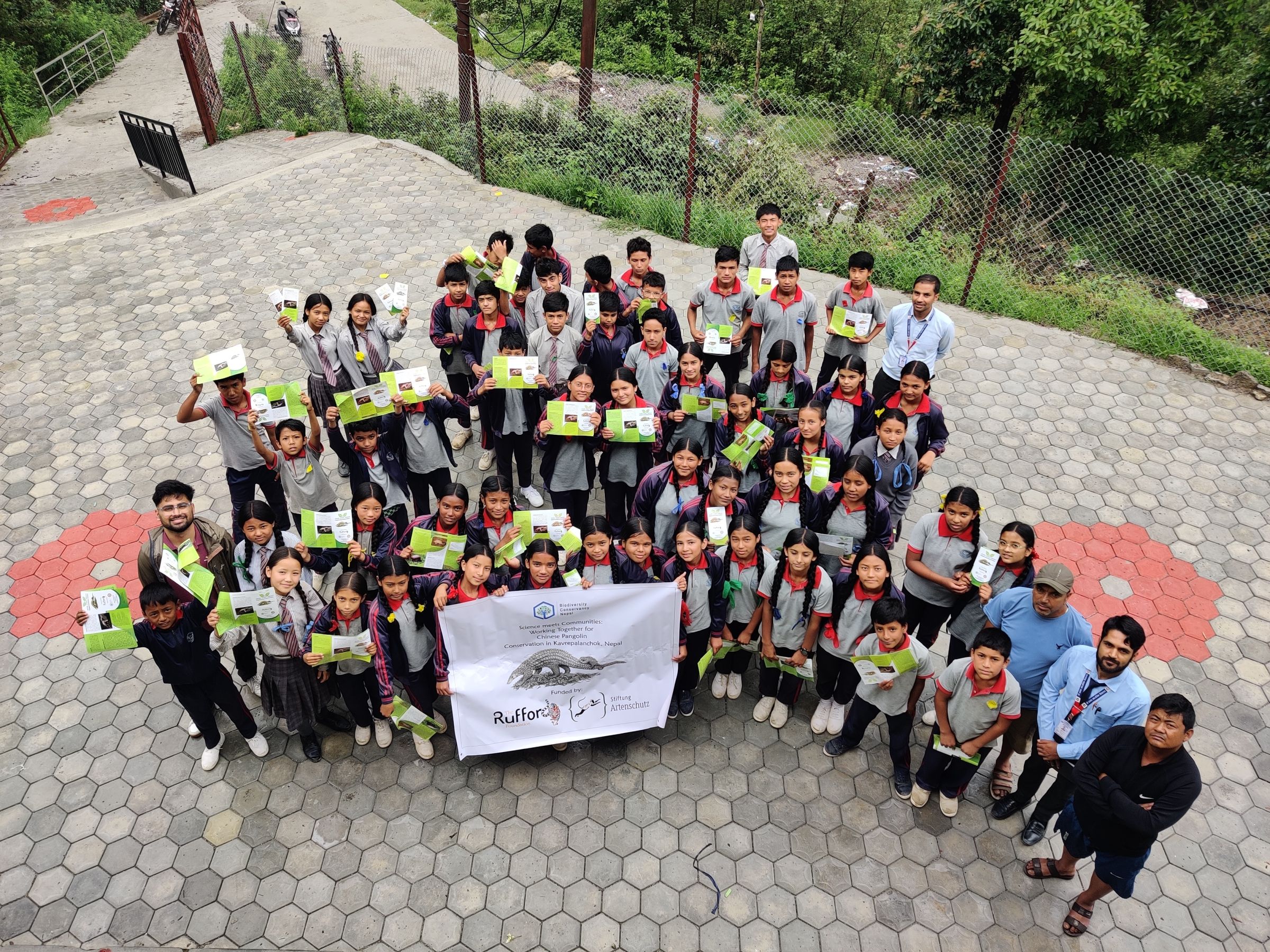 A group of students holding up a sign.