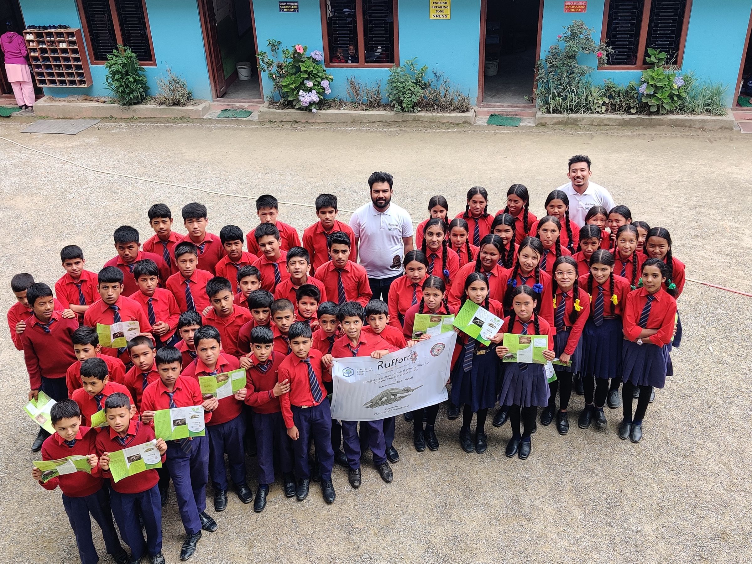 A large group of students holding up a sign.