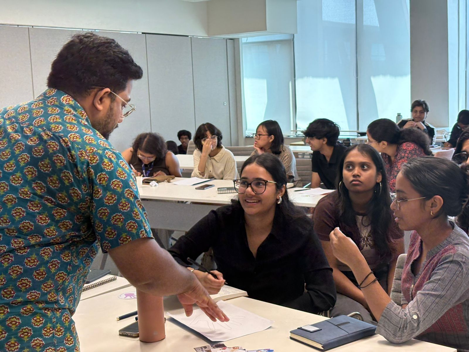A teacher talking with a group of students.