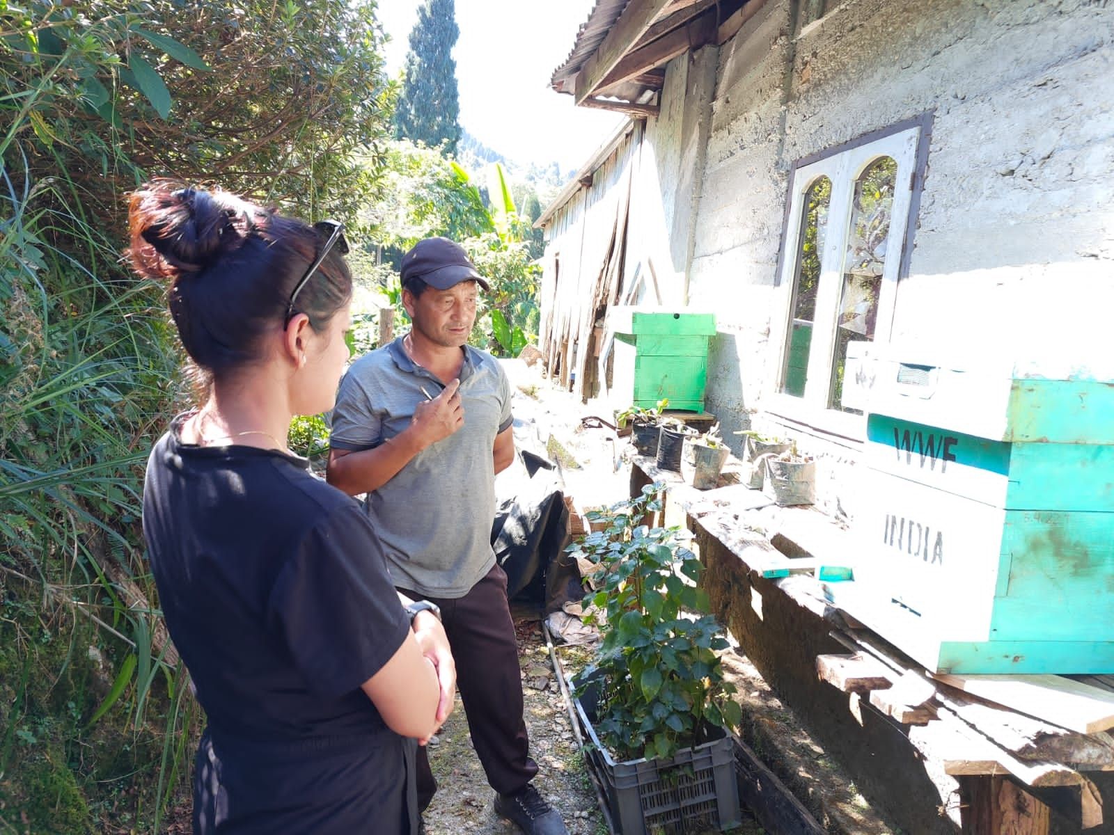Ambreen talking to another community member outside in their garden