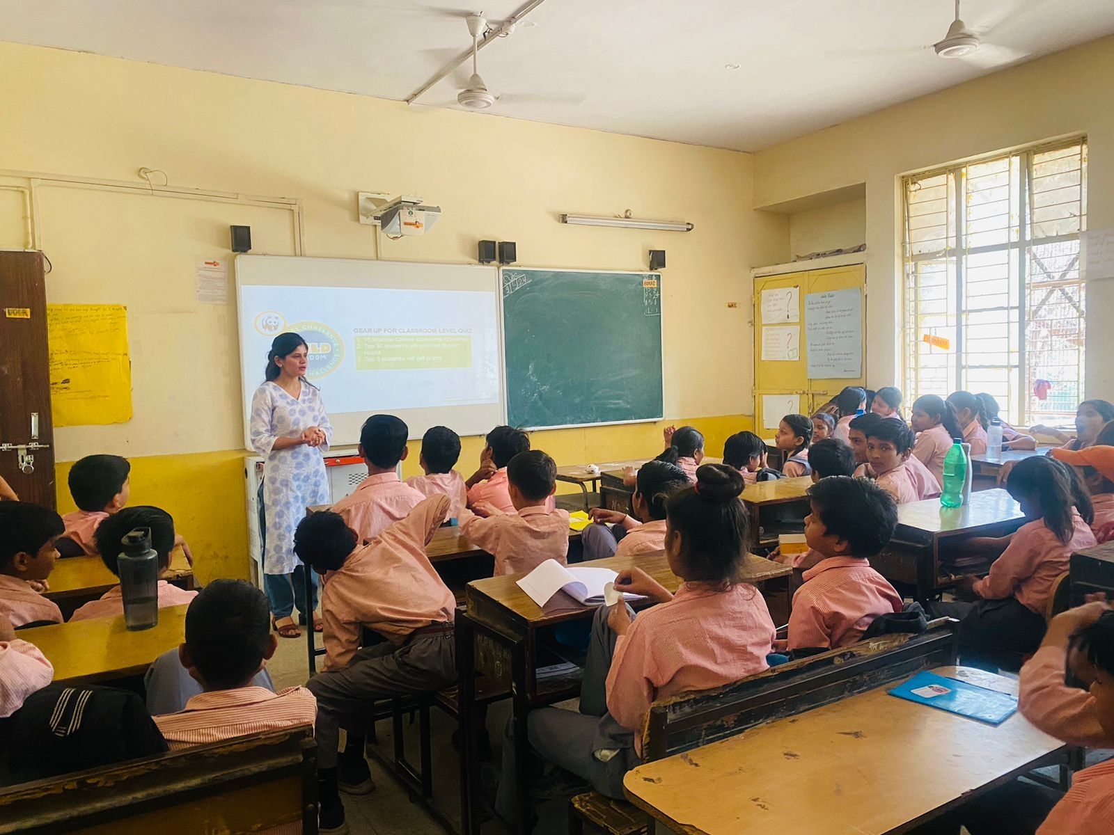 Ambreen speaking in front of a classroom