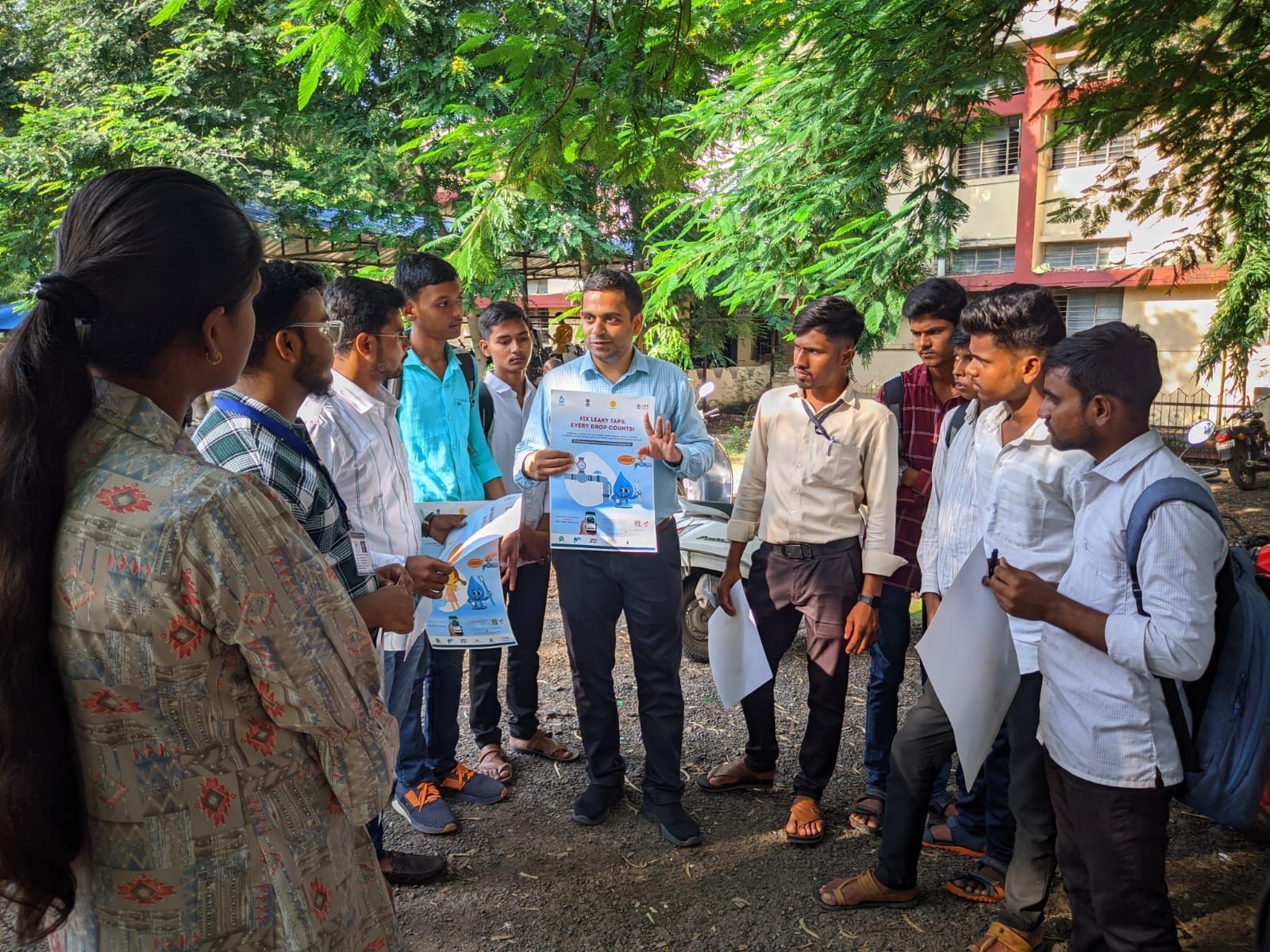 Avadhut talking to students outside in a semi circle