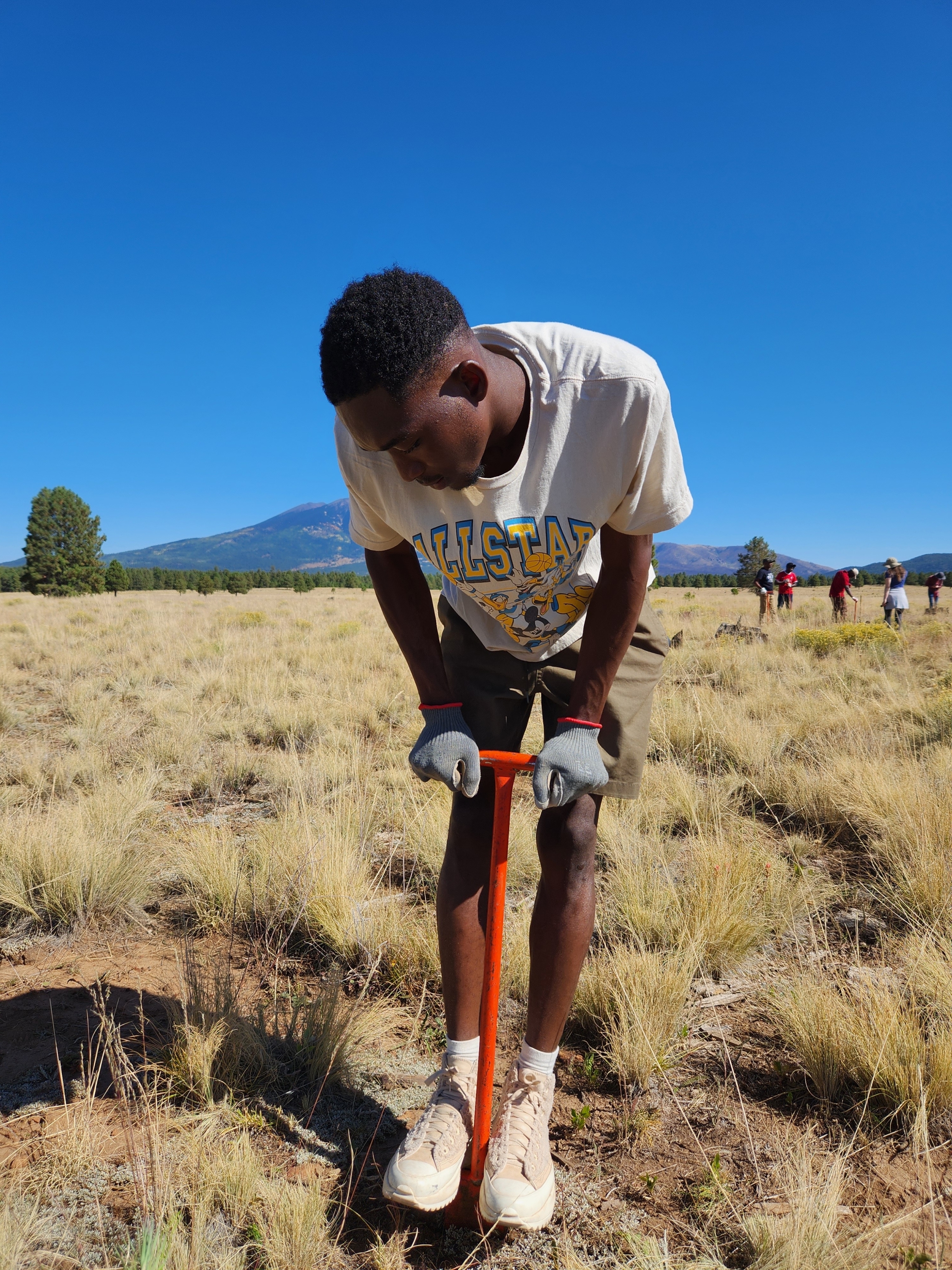 Caleb digging a hole outside