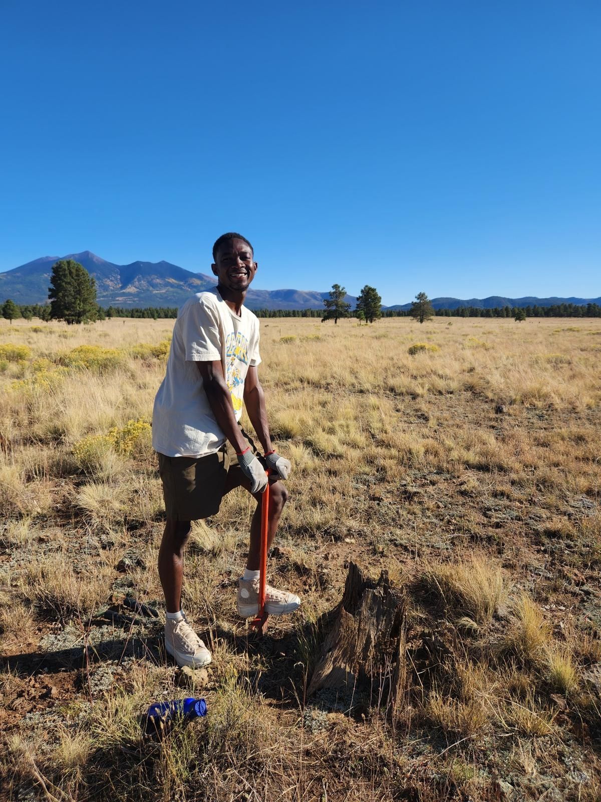 Caleb outside planting a tree