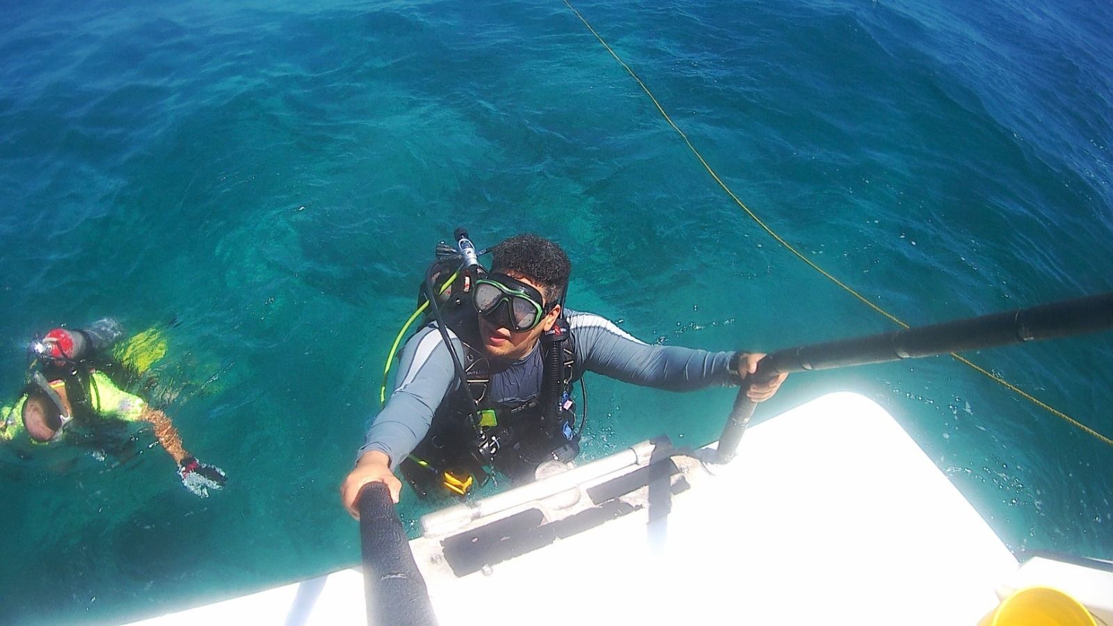 David in the ocean about to board a boat