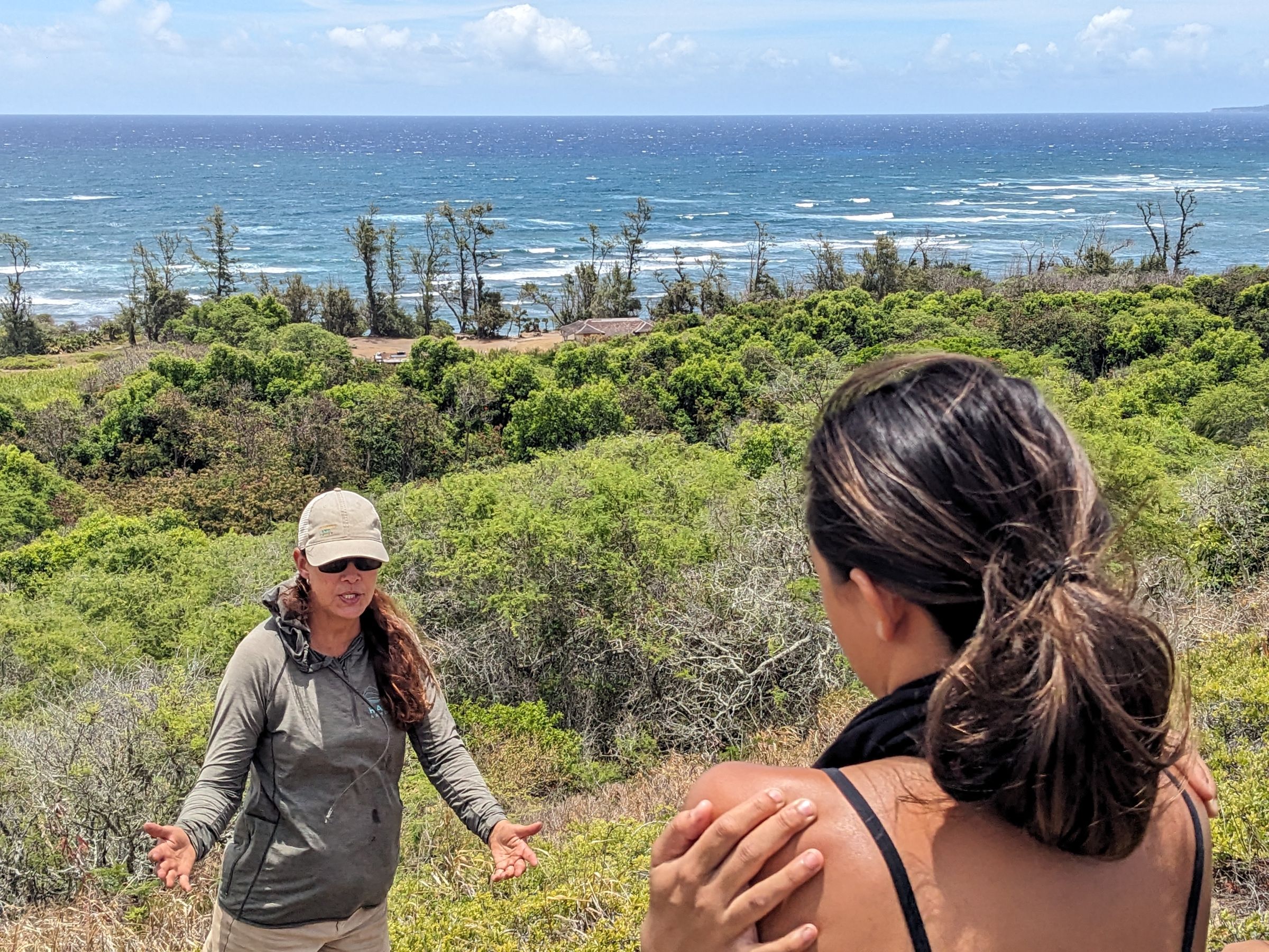 Denby outside with the ocean behind her