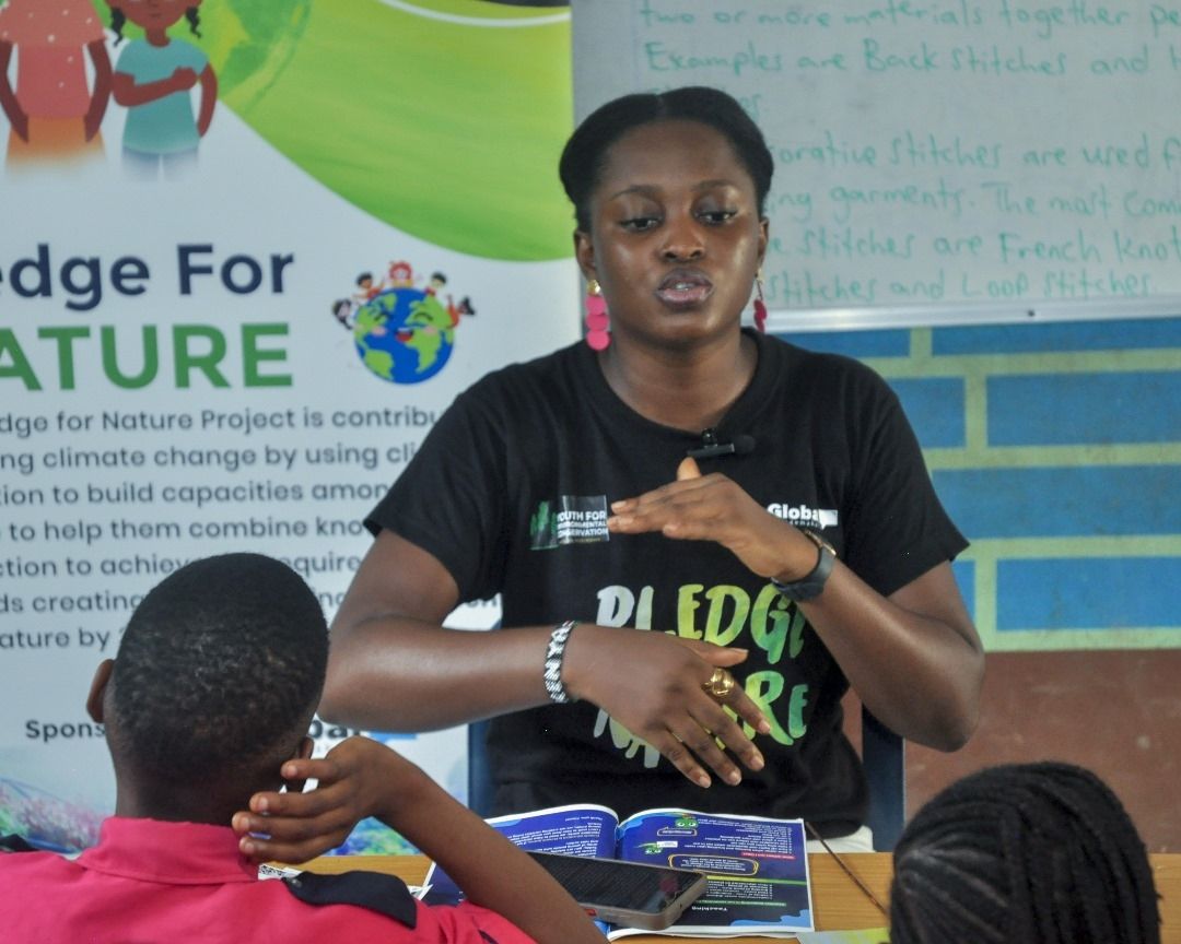 Favour speaking to students in a classroom