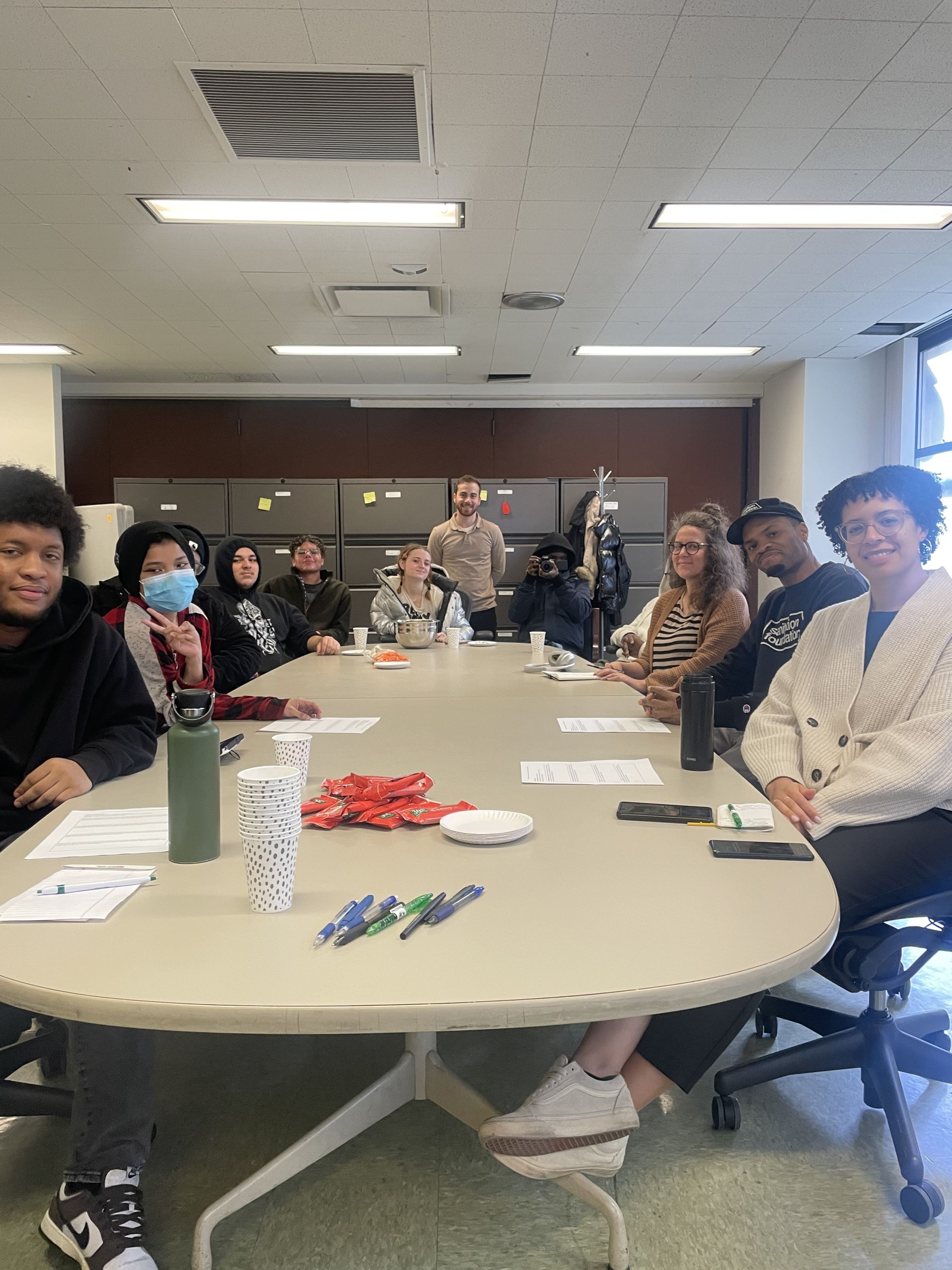 Smiling faces sitting around a conference table