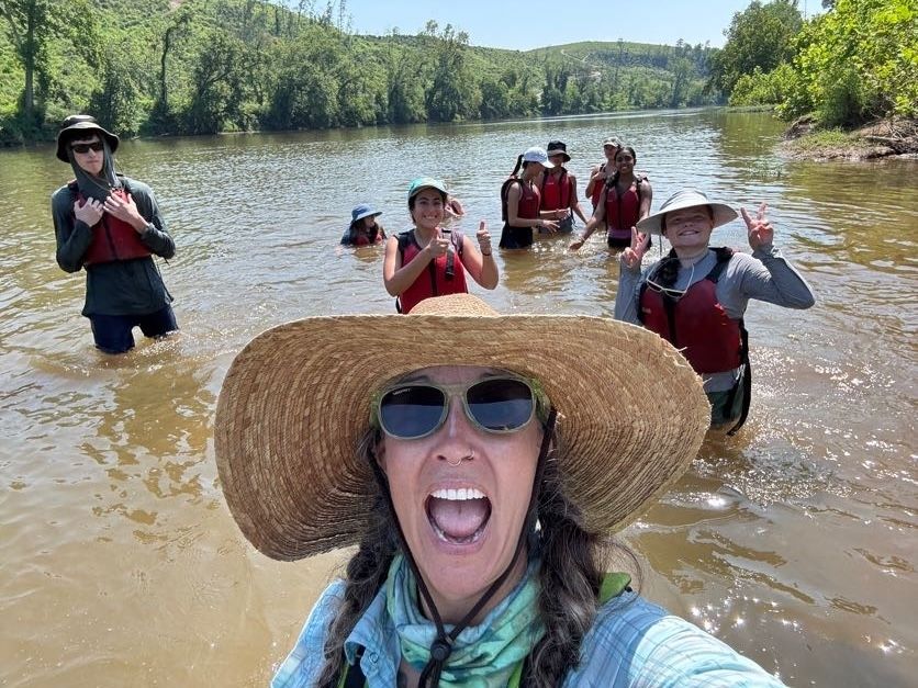 Teresa and students playing in the river
