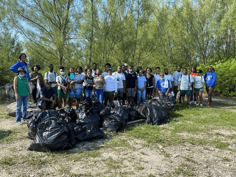 Group of people posed together outside for an International Coastal Cleanup Day