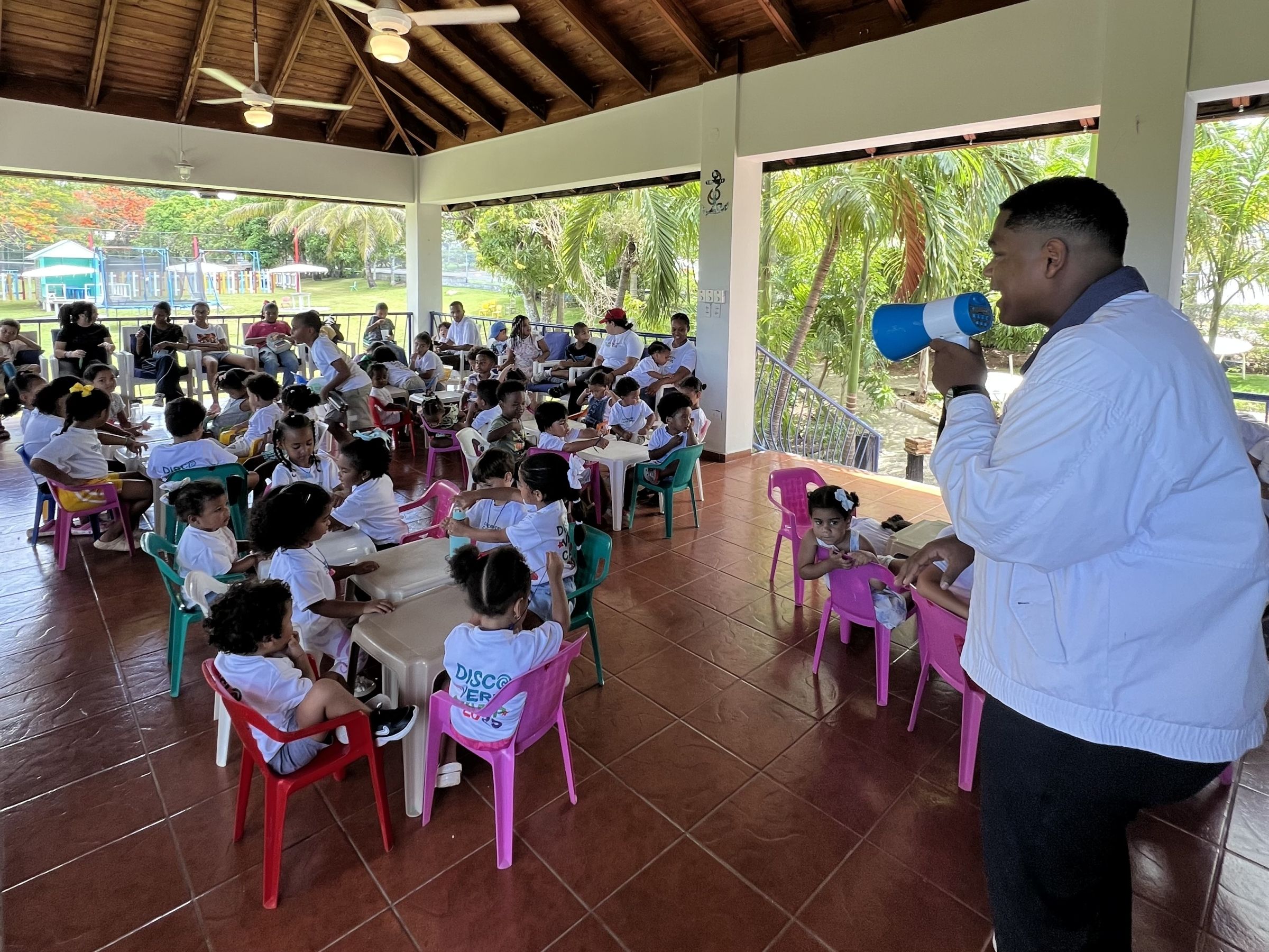 Angel stands at the front of a classroom of several students
