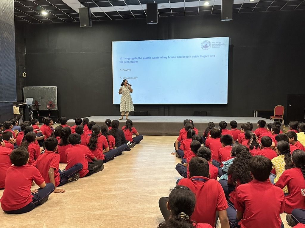 Anooja in front of sitting children