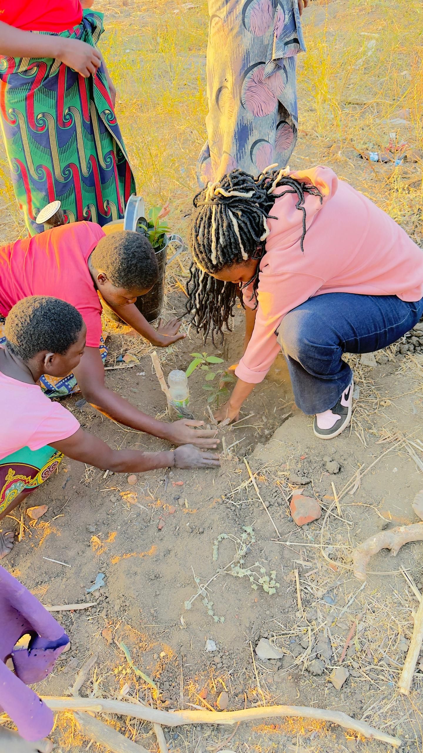 Two young students plant a tree